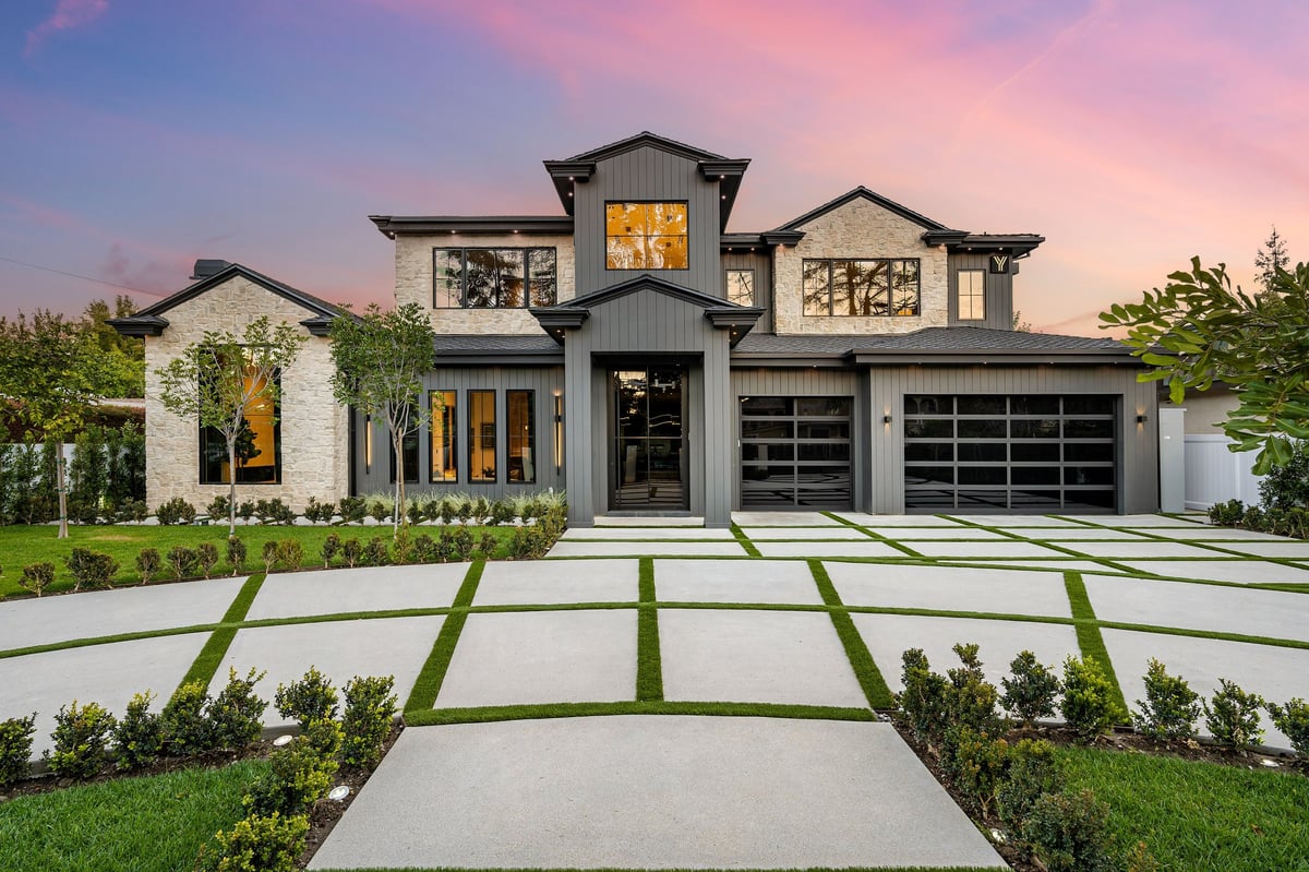 Woodstock-area modern home with a landscaped front yard at sunset